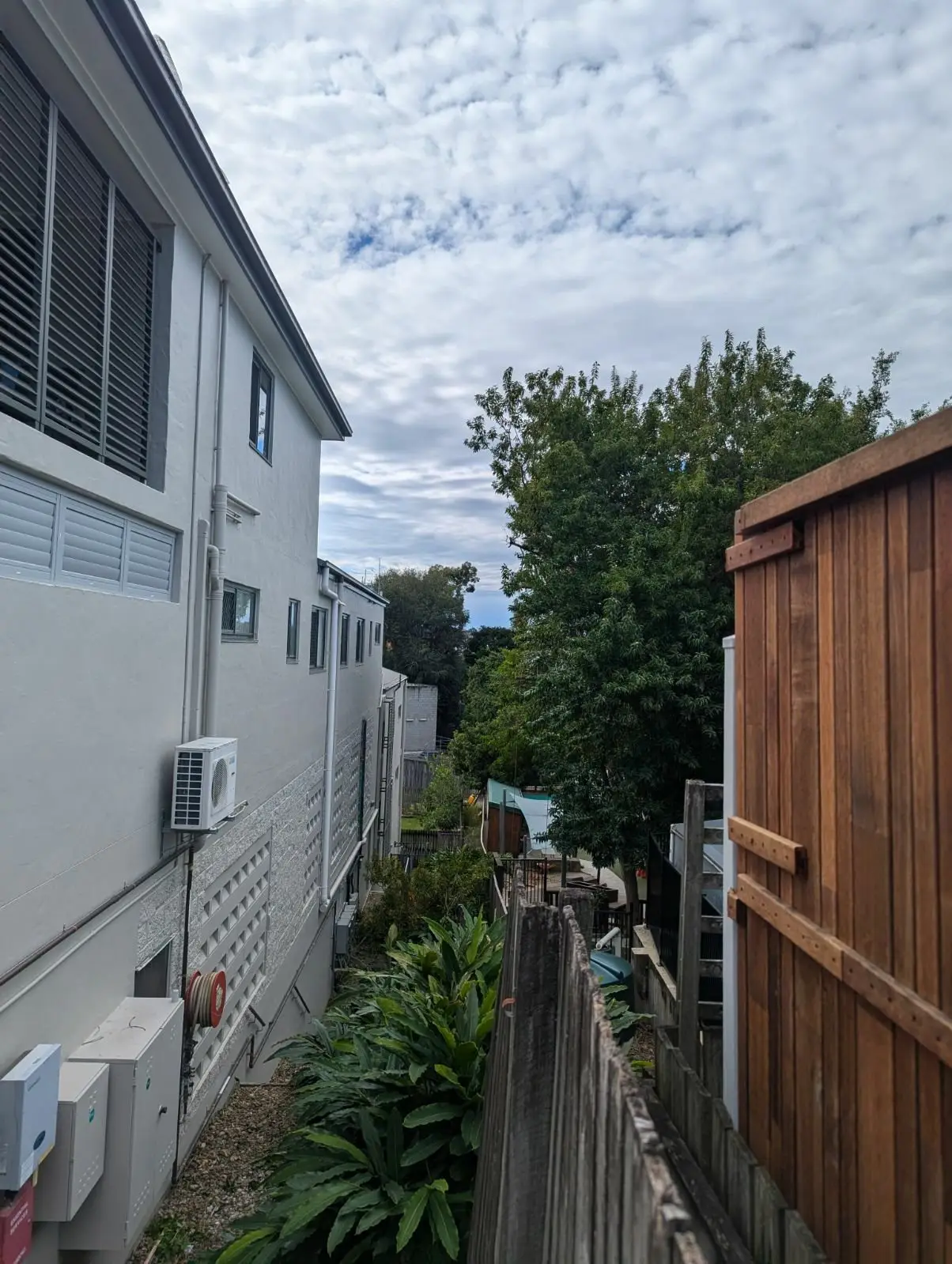 Childcare yard after tree lopping with the canopy cleared from the fence line