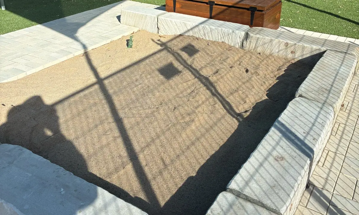Custom sandstone sandpit with timber bench seating, Mackay childcare centre