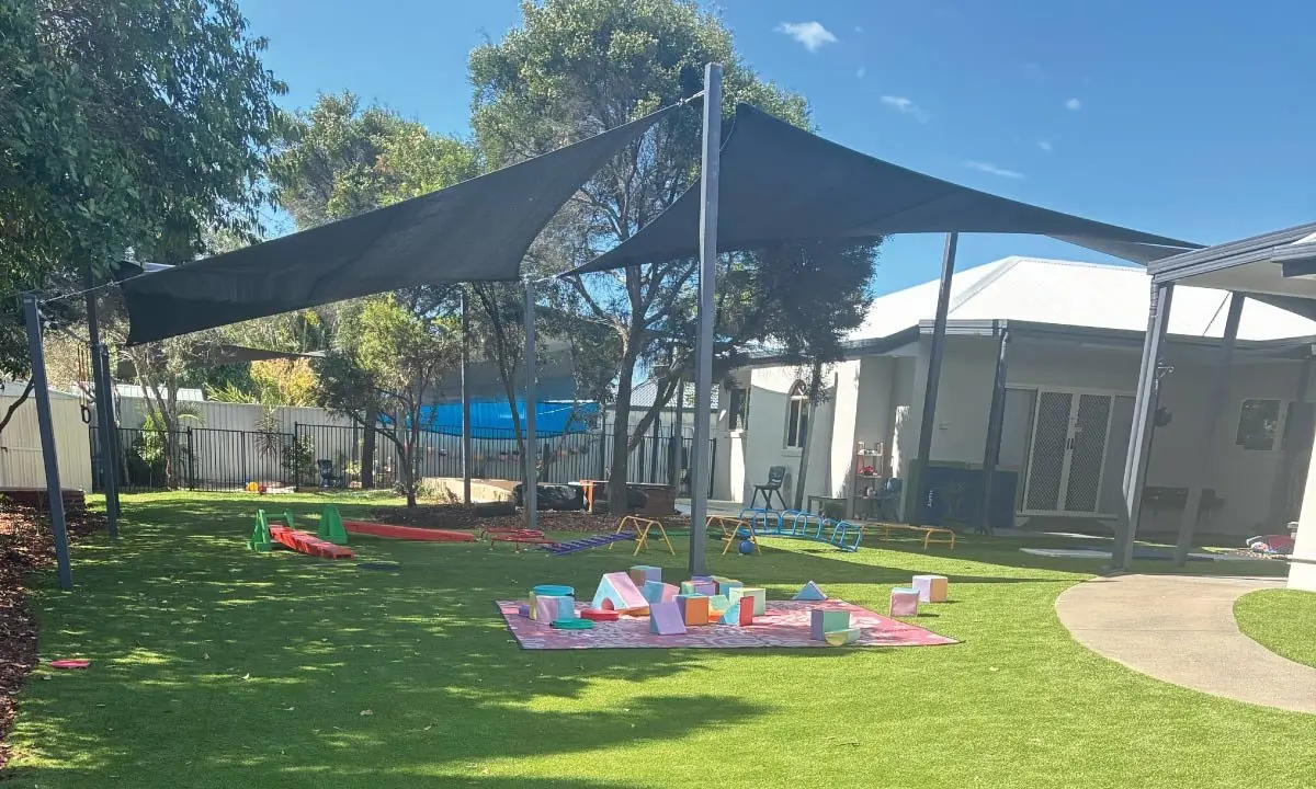 Shade sail over new synthetic turf with soft play blocks, Point Vernon childcare centre