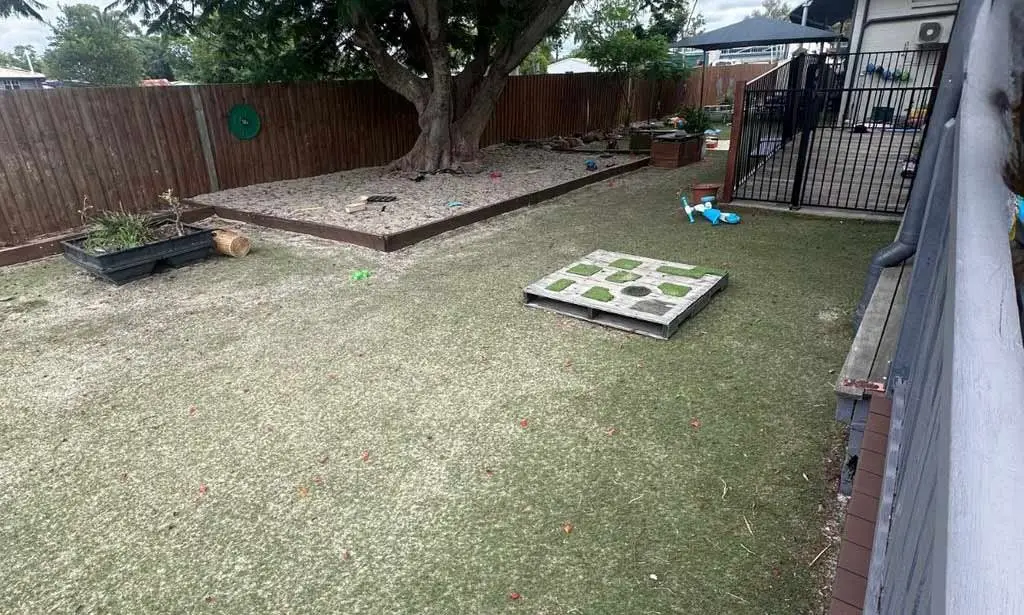 Bare dirt yard with old timber frames before the upgrade, Dalby