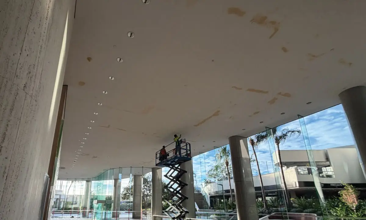 Stained foyer ceiling with a scissor lift in place before works, Eagle Street