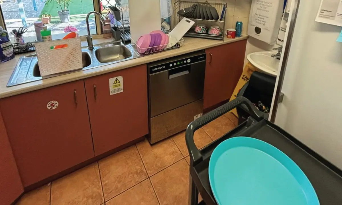 Old kitchen with red laminate cabinets before the upgrade, Point Vernon