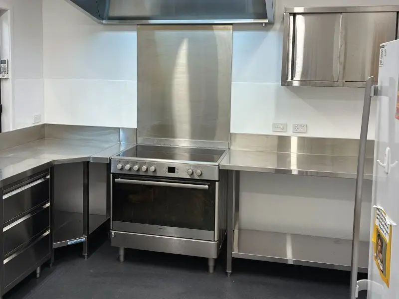Commercial oven and stainless steel benches in the new kitchen