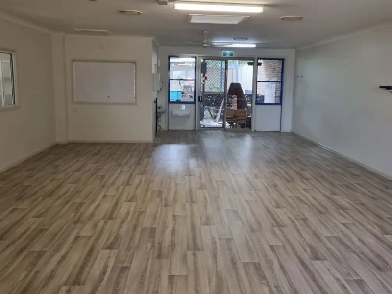 Reinstated playroom with new vinyl flooring and glass doors to the yard