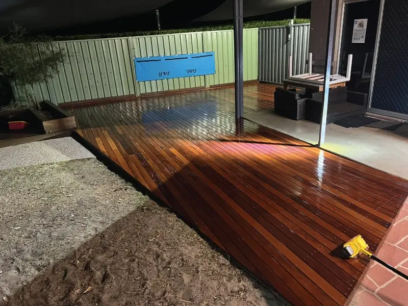 New hardwood decking laid under lights during the weekend works