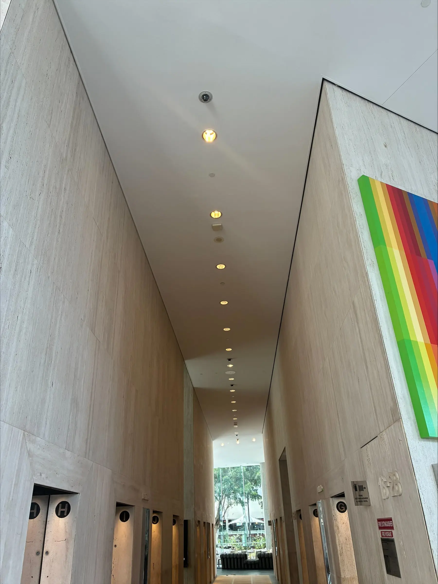 Scissor lift on protected marble flooring under the foyer ceiling