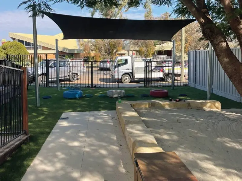 Sandstone sandpit with timber deck edge under a new shade sail