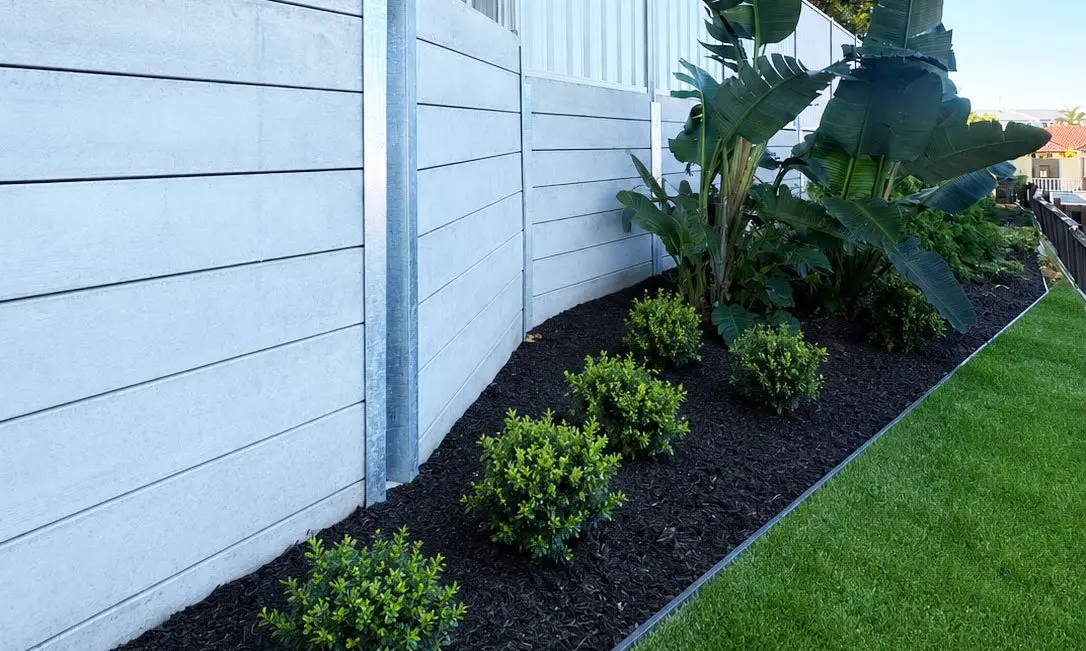 New concrete sleeper retaining wall with garden bed and synthetic grass, Robina childcare centre