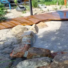 New timber deck and sandstone creek bed in a childcare nature play yard