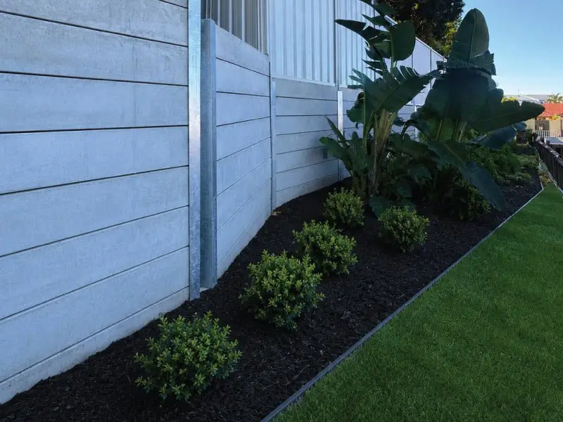 Concrete sleeper retaining wall with new plantings along the boundary