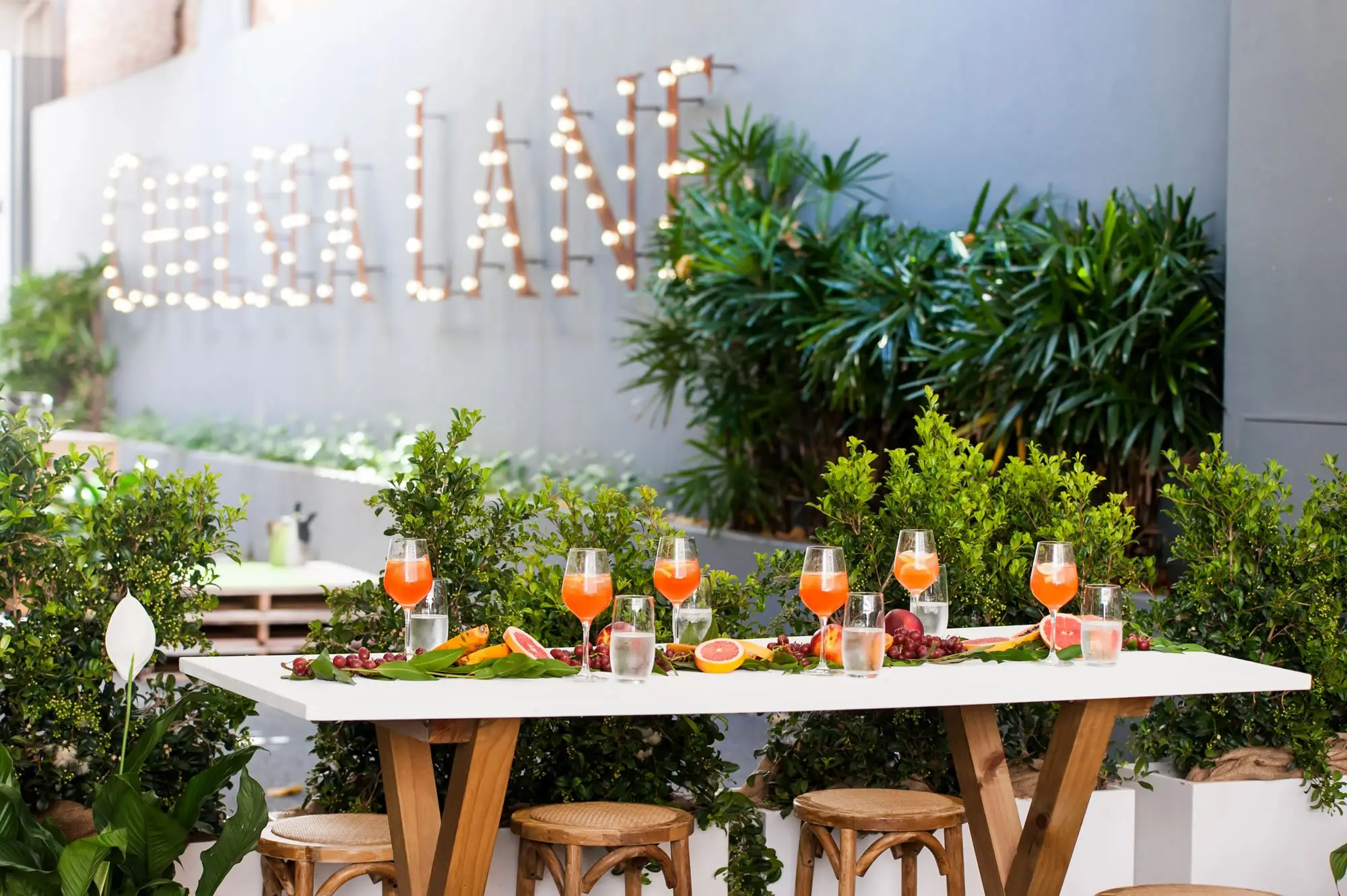 Timber tables set for a function along Chelsea Lane