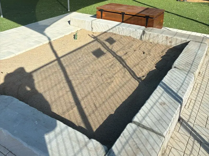 Sandstone sandpit from above with paving surround