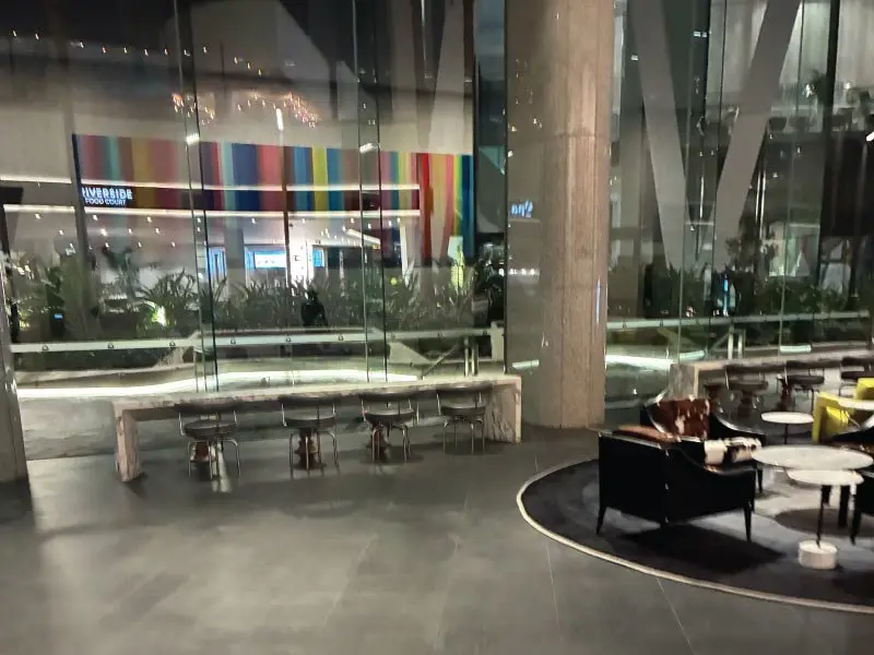 Ground floor foyer lounge with yellow chairs and artwork