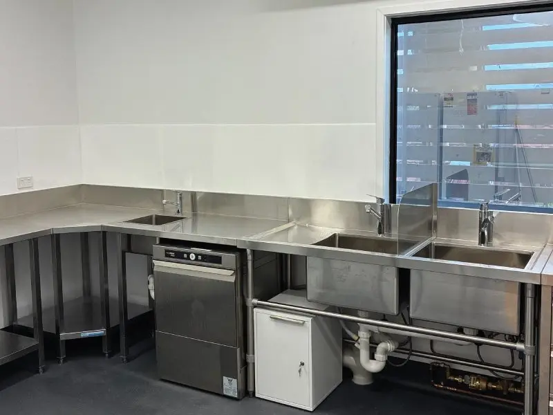 Stainless steel bench with commercial dishwasher
