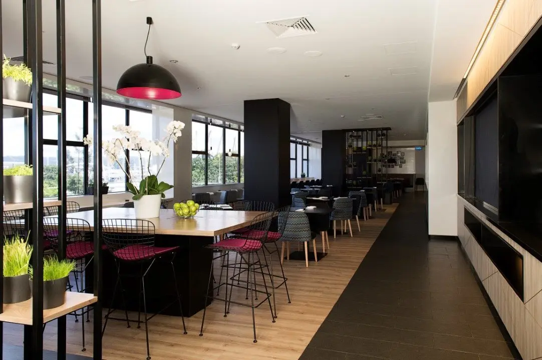 Refurbished Mercure Brisbane restaurant with timber-panelled buffet and pink stools