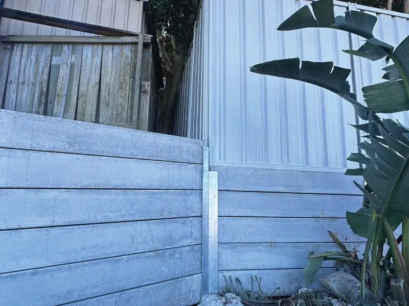 Concrete sleeper wall topped with Colorbond fencing