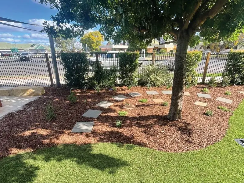 Garden bed with sandstone steppers under an established tree