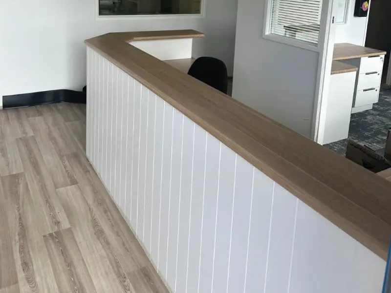 Half-height partition with timber bench top in the rebuilt room