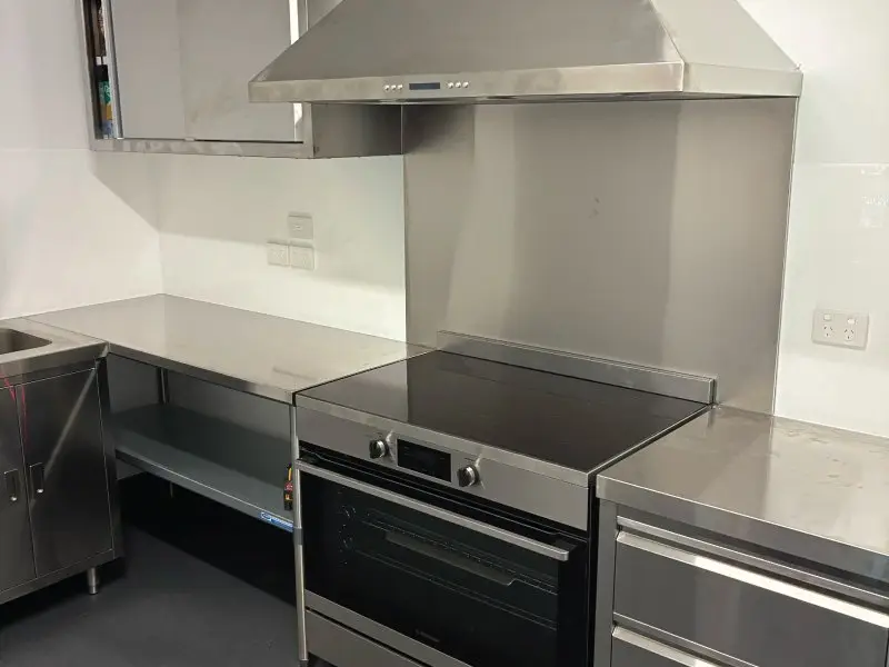 Stainless steel benches and commercial oven in the new kitchen