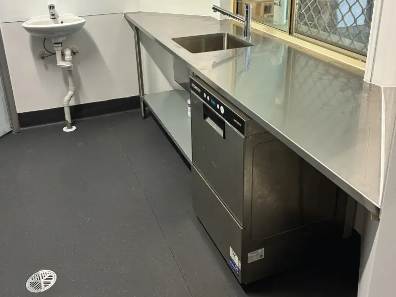 Stainless steel bench with commercial dishwasher
