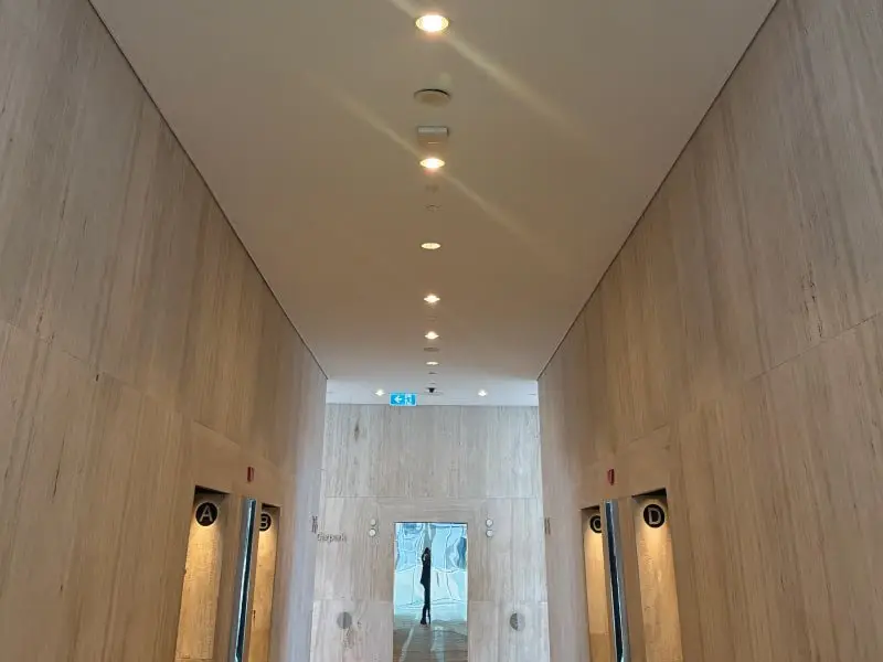Completed lift lobby corridor with timber-look panels