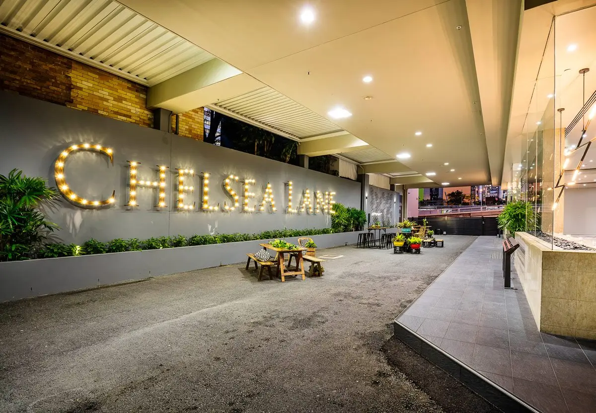 Chelsea Lane sign lit at night with the laneway set for an event