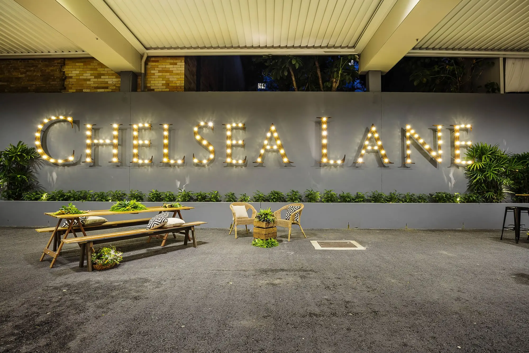 Chelsea Lane sign and timber tables under the Vergola roof